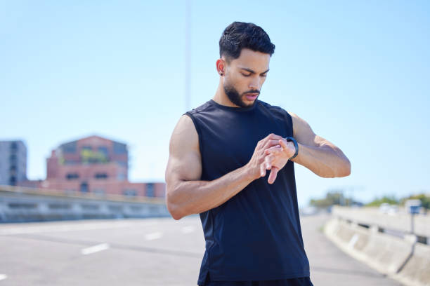 istock Man check running stats, health and wellness performance or workout endurance on watch tech. Young athlete cardio training, healthy exercise and sport lifestyle or wellness motivation 1446116864