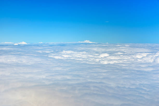istock Clouds against blue sky view through an airplane window for a background. 1446117156