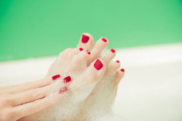 istock woman hands and feet covered with foam 1446117742