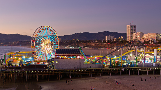 Aerial shot of the Santa Monica Pier in Santa Monica, California at dusk. Authorization was obtained from the FAA for this operation in restricted airspace.