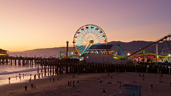 Aerial shot of the Santa Monica Pier in Santa Monica, California at dusk. Authorization was obtained from the FAA for this operation in restricted airspace.