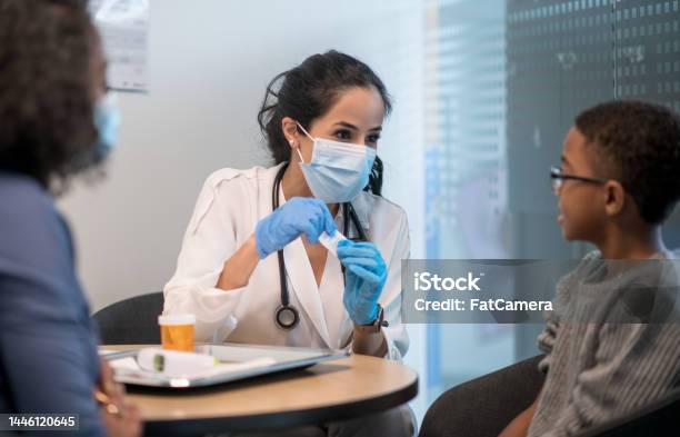 Getting Boosted Stock Photo - Download Image Now - Doctor, Protective Face Mask, 25-29 Years
