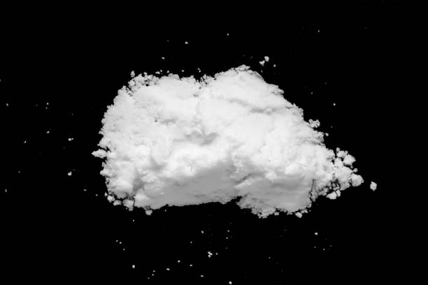 istock White snow isolated on black background close up 1446120671