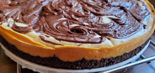 Chocolate swirl cheesecake crust on a cooling rack stock photo