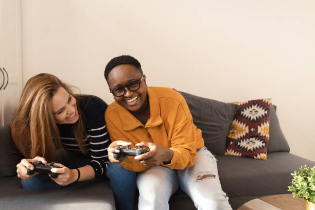 istock Sisters playing video game at home 1446121078
