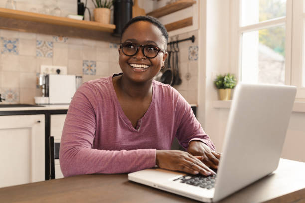 istock Happy young woman enjoying working online 1446122533
