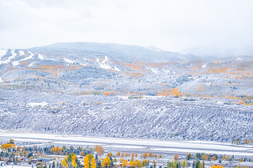 Aspen, Colorado town in rocky mountains roaring fork valley from high angle view of airport during autumn season and snow in October
