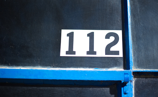 112 Number on Blue-Paned Black Window