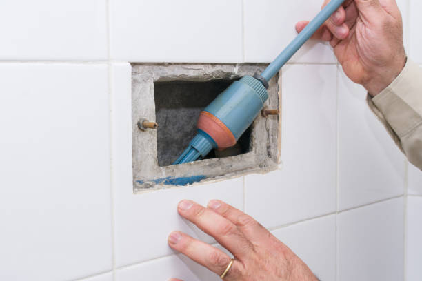 istock Professional plumber working with toilet bowl in bathroom. Float replacement 1446132546