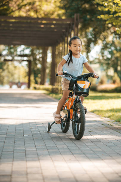 istock Young dad teaching his kid to ride a bike 1446135294