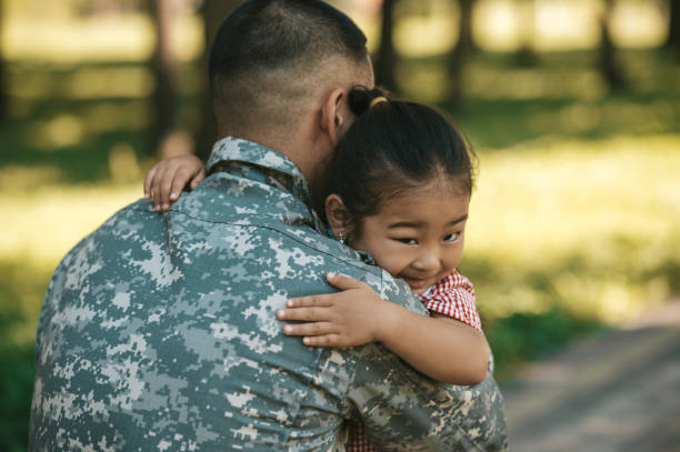 istock Little girl looking happy while hugging her dad after long parting 1446135353