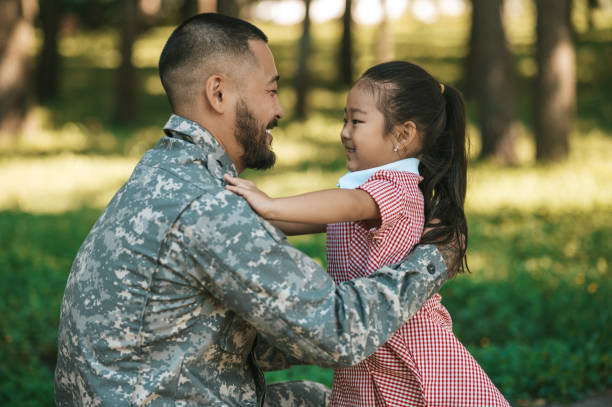 istock Little girl looking happy while hugging her dad after long parting 1446135359
