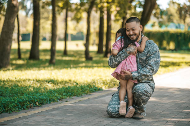 istock Little girl looking happy while hugging her dad after long parting 1446135360