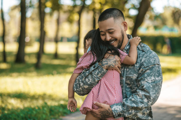 istock Service man hugging his little daughter and looking happy 1446135363