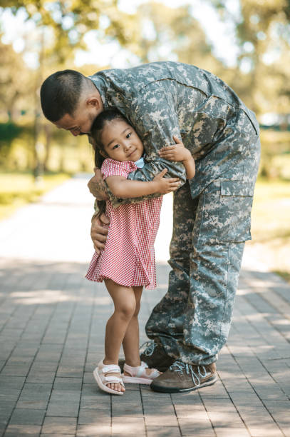 istock Service man hugging his little daughter and looking happy 1446135366