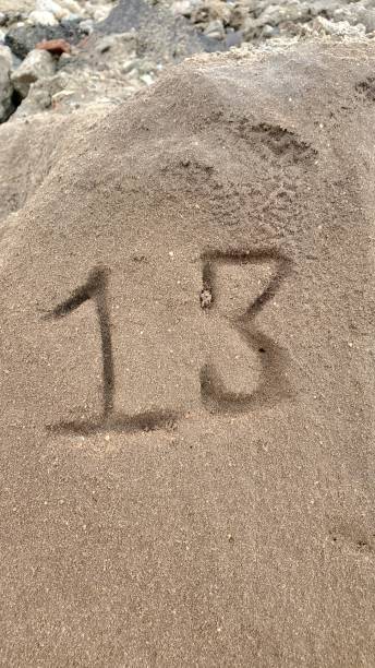 istock Number 13 on sand stone 1446137274