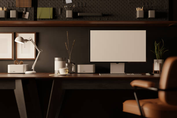 istock Modern stylish office desk with computer mockup on table against the black wall with black pegboard 1446140401