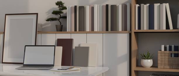 istock Minimalist white home working space with laptop mockup, books, decor plant and frame mockup 1446140423