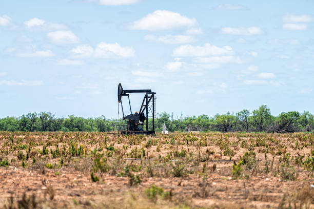 Sweetwater, Texas oil pumpjack on Oilfields of USA with metal machine in brown field on sunny summer day with blue sky and nobody in landscape Sweetwater, Texas oil pumpjack on Oilfields of USA with metal machine in brown field on sunny summer day with blue sky and nobody in landscape abilene texas stock pictures, royalty-free photos & images