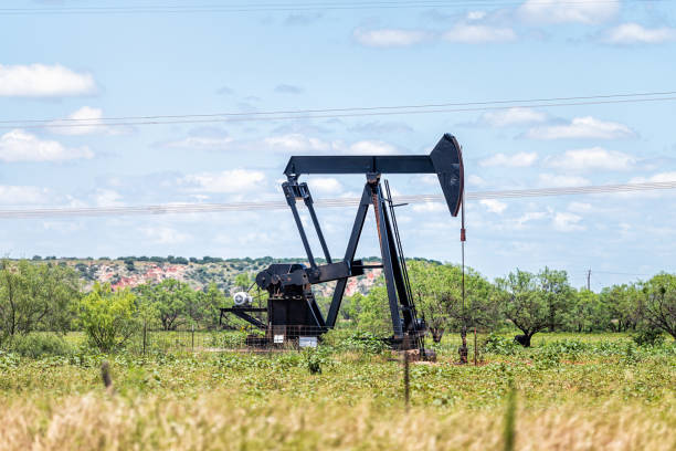Sweetwater, Texas oil pumpjack on Oilfields in prairies with metal machine in field on sunny summer day with blue sky and nobody in landscape stock photo