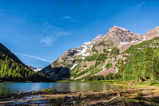 Aspen, Colorado Maroon Bells area with Crater lake water and rocky mountain peak in summer on trail wide angle view with avalanche debris logs