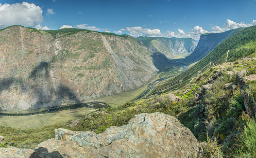 Deep mountain gorge with a river, rocky slopes, top view