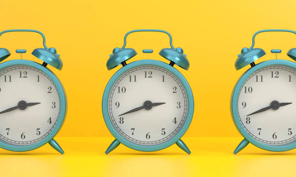 istock 3 Alarm Clocks On Yellow Background 1446154343