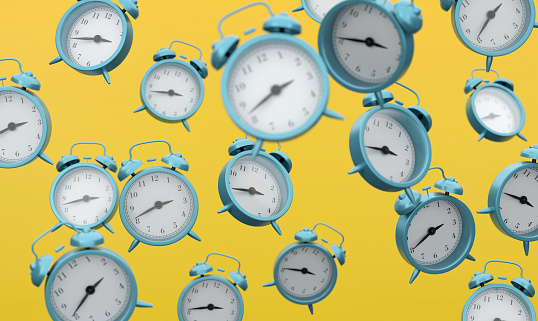 Alarm Clocks On Yellow Background. Time Concept.