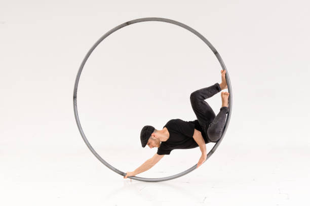 istock Male acrobat performing trick in hoop 1446154528