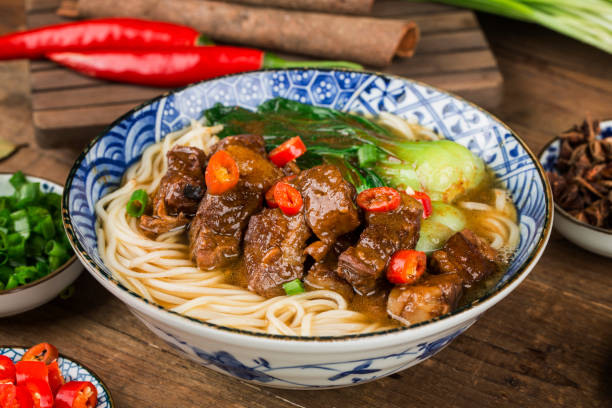 istock Spicy red soup beef noodle in a bowl on wooden table 1446156596
