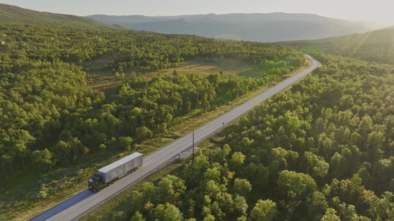 Scenic aerial view of truck on the road through Norwegian highlands