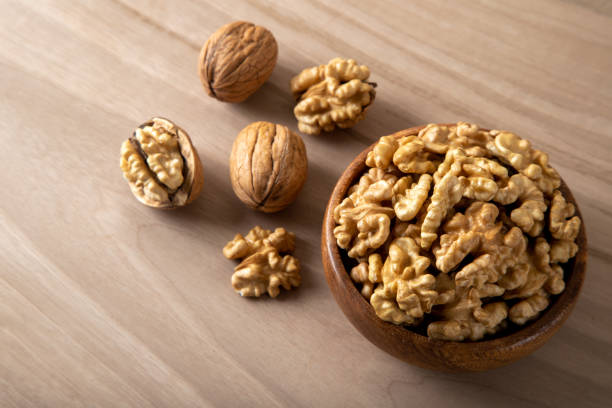 istock Group of peeled walnuts and whole walnuts,directly above 1446158225