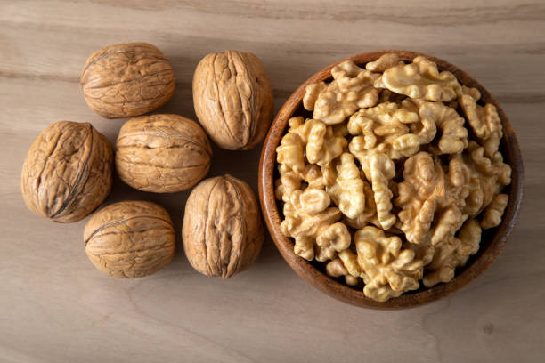 istock Group of peeled walnuts and whole walnuts,directly above 1446158238