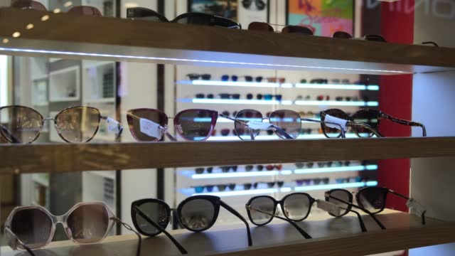 Optics shop. The windscreen offers a wide selection of sunglasses. From glasses with brown, gray and green lenses to red in a fashionable, light frame and different materials.