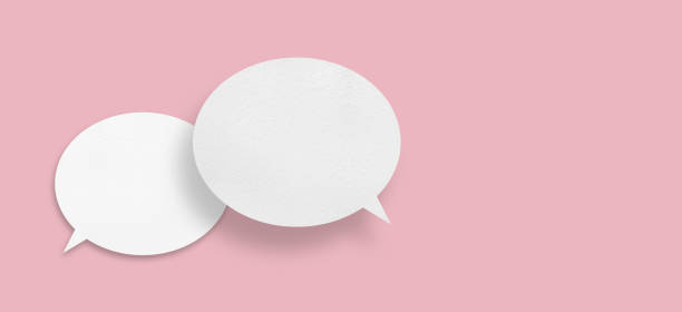 istock Round white paper with speech bubbles isolated on pink background communication bubble . 1446159235