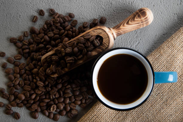 istock A blue cup of coffee with roasted coffee beans, directly above 1446159371