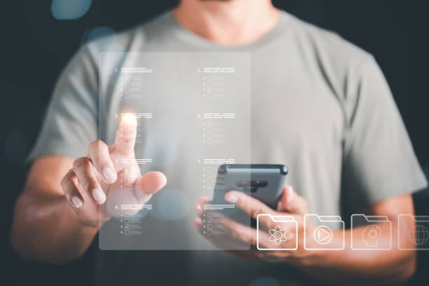 istock Man using smartphone to choose correct answer, marking online,online survey concept online exam filling out survey forms,using technology for education,learning assessment through online documents 1446160335