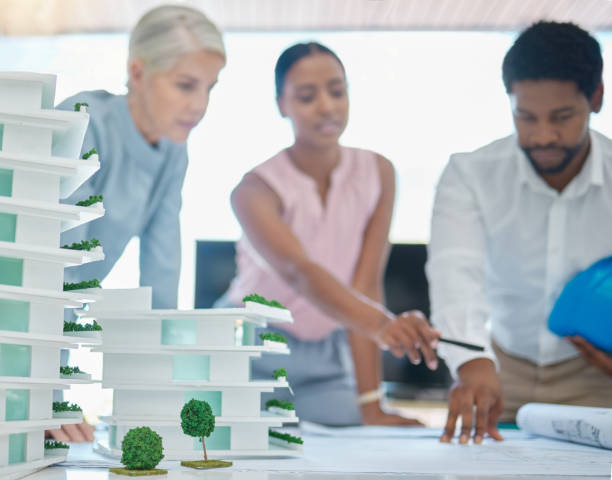 istock Architect or engineer team planning and designing a building in a meeting in the office or boardroom. City development planner or architecture group with a 3d model and working on a strategy 1446160537
