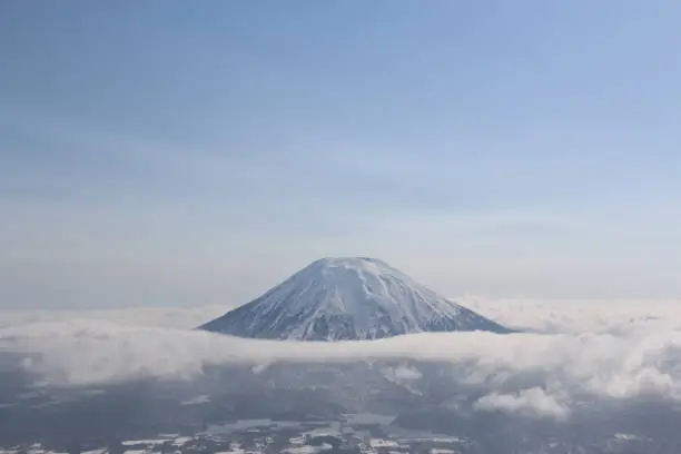 Landscape high angle view of Mt. Yotei, Niseko, surrounded by clouds
