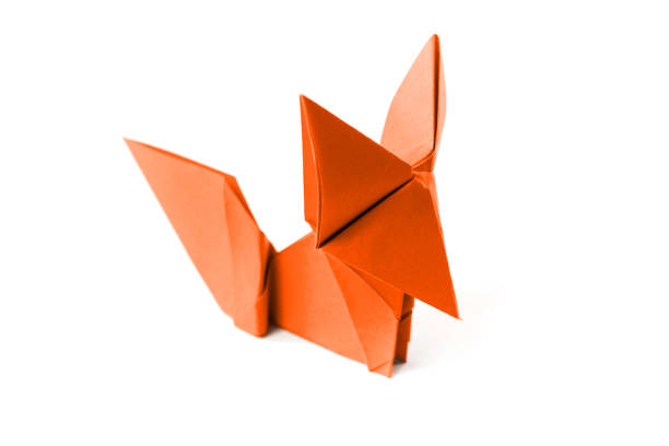 Orange paper fox origami isolated on a blank white background.