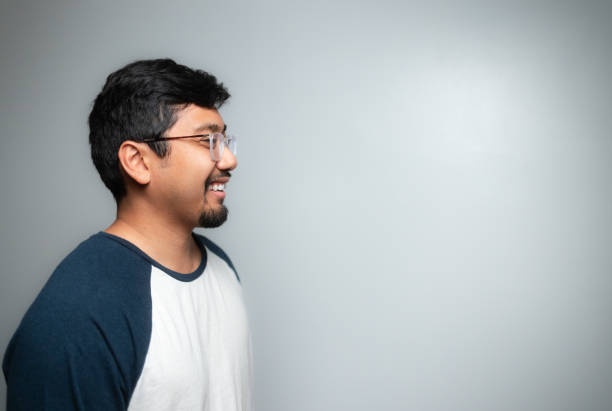 istock Studio Portrait - Asian Man - Soft Grey Background - Positive Emotion - BaseBall Shirt - Profile 1446168780