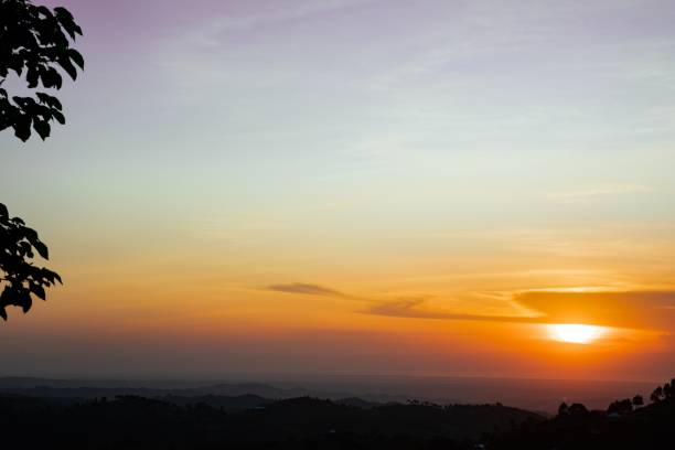 istock Mesmerizing sunset view with bright sun and clouds above the city 1446171196