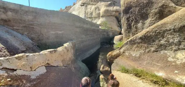 Photo of Hiking along the Barker Dam Nature Trail in Joshua Tree, view of river flowing between rocks