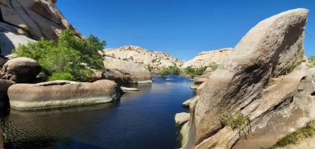 Photo of Along the Barker Dam Nature Trail in Joshua Tree, beautiful view of river flowing between the rocks