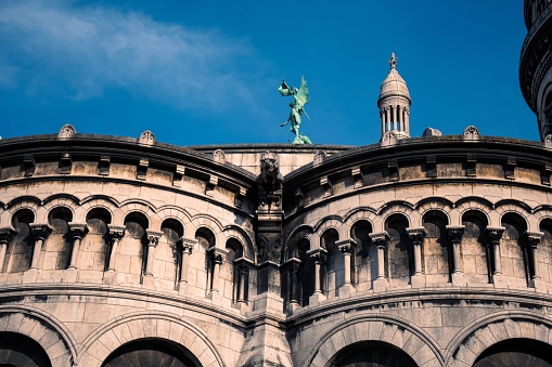 The bronze statue of St. Michael slaying the dragon on the roof of the Basilica of the Sacred Heart of Paris