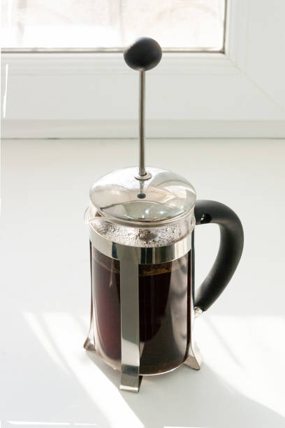 istock coffee is brewed in a french press, the shadow from the window 1446175654