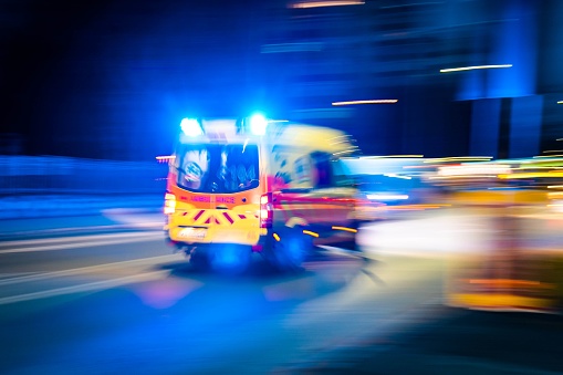 The ambulance circulating the streets at night, close-up, long exposure