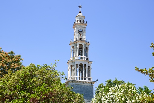 the large marble neoclassical bell tower - clock of the church of Agios Apostolos. This is an excellent example of architecture.. Argalasti, Greece