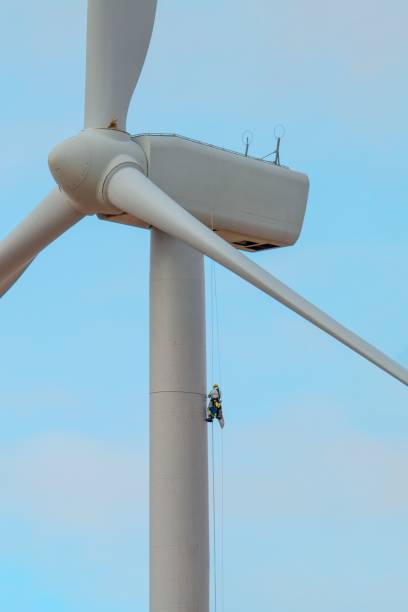 istock Vertical shot of worker on giant white wind turbine 1446178240