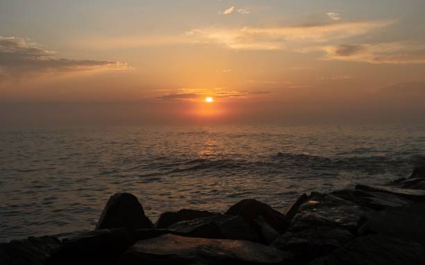 istock Beautiful seascape from the rocky shore at sunset. 1446179122